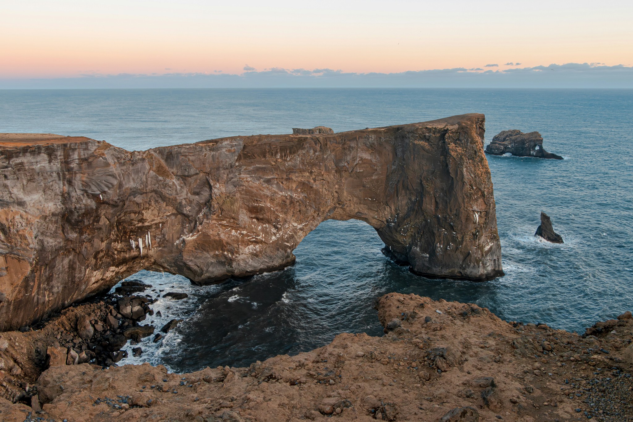 Dyrhólaey rock arch under a dusky sky in South Iceland.
