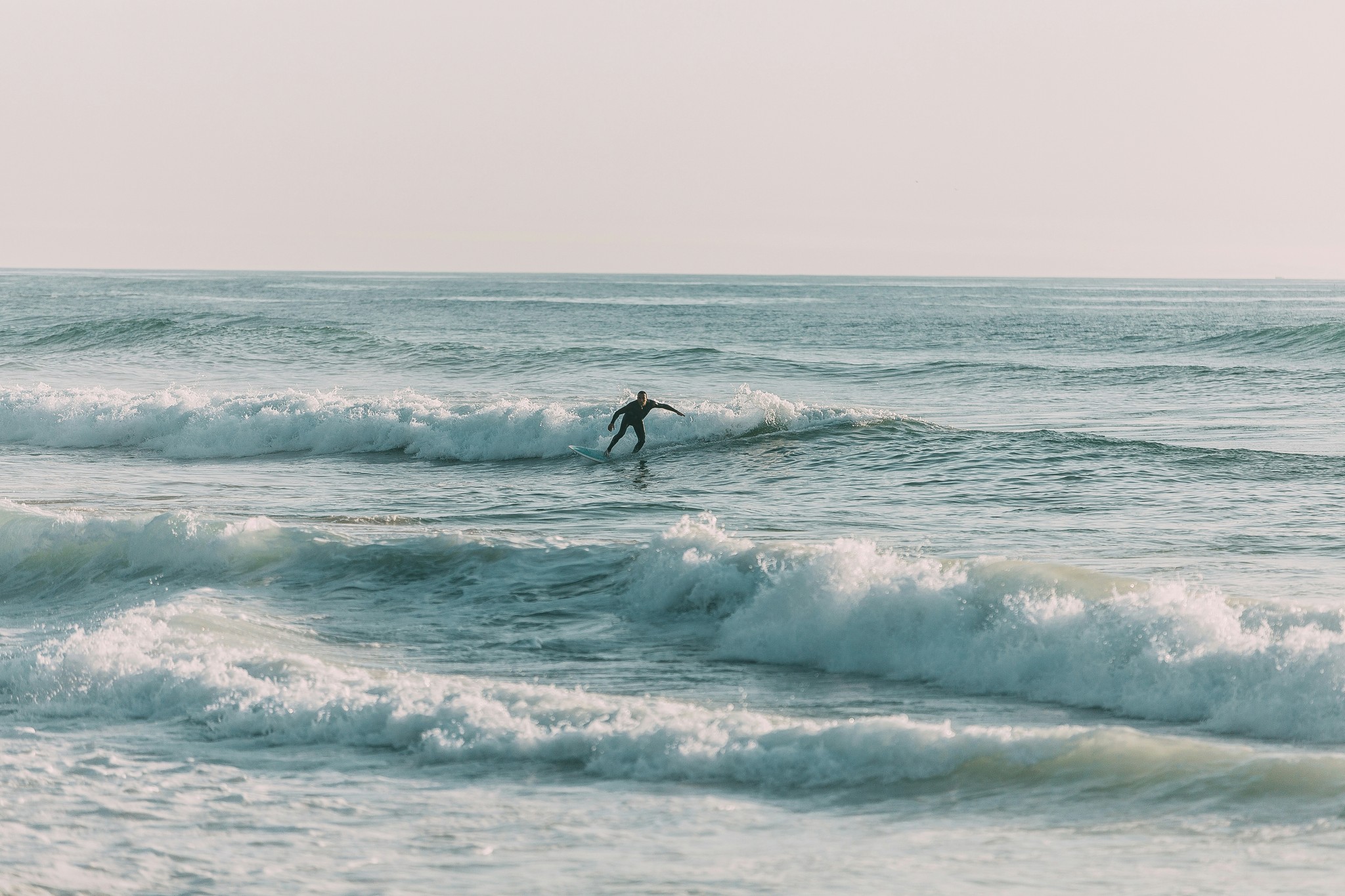 A person surfing off the coast of Ölfus in South Iceland.