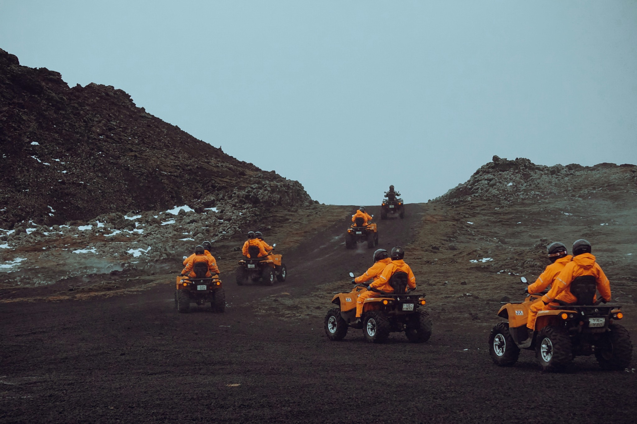 Tourists riding ATVs across Iceland’s rugged lava fields.