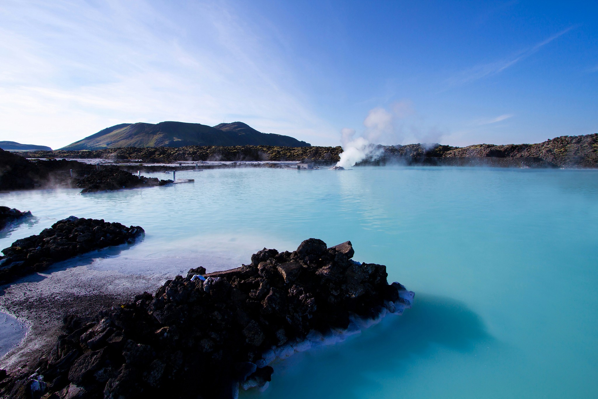 Steam rising from the milky-blue waters of the Blue Lagoon in Iceland.