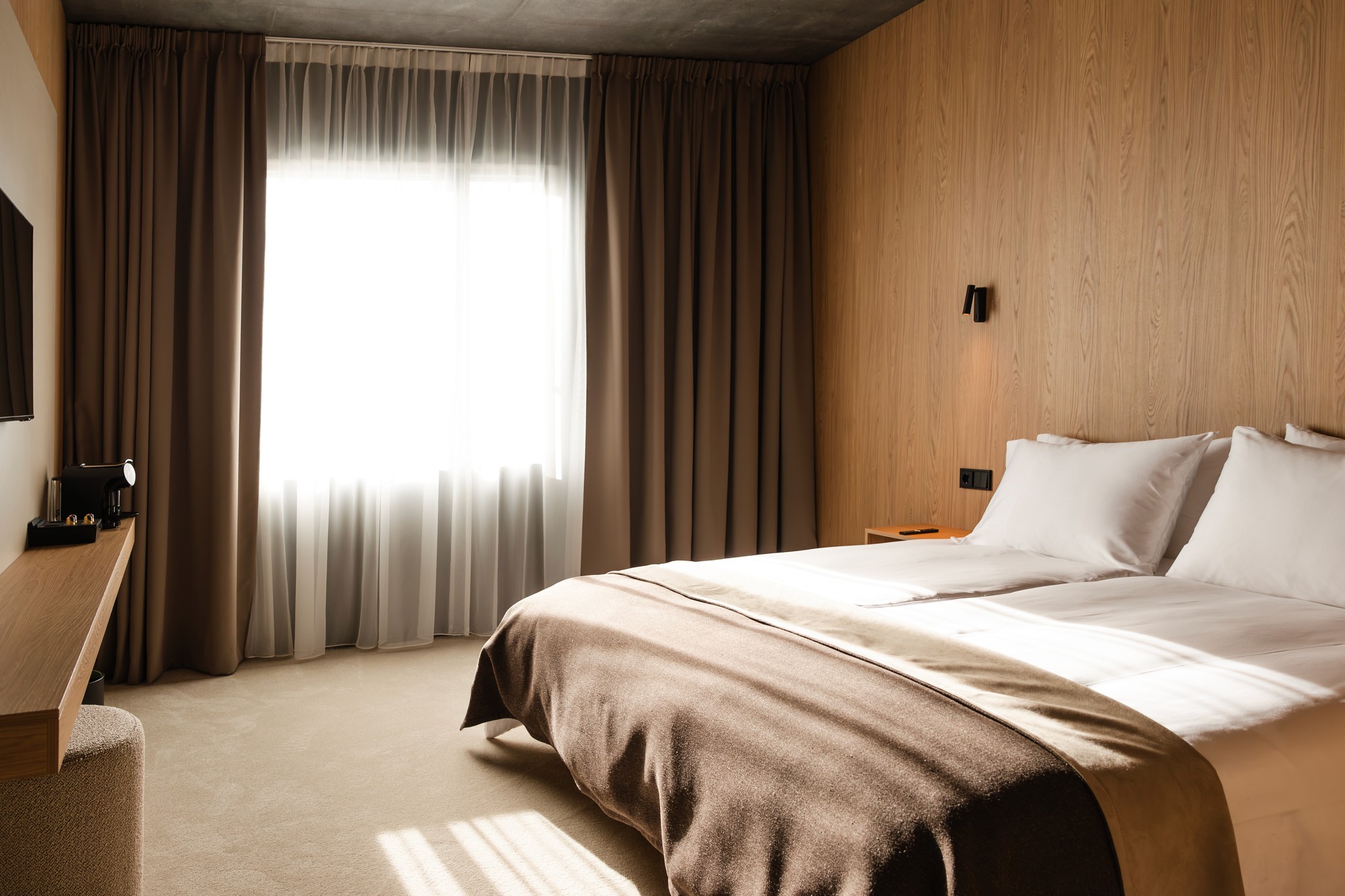 Classic King room with wood panelling and a DUX bed