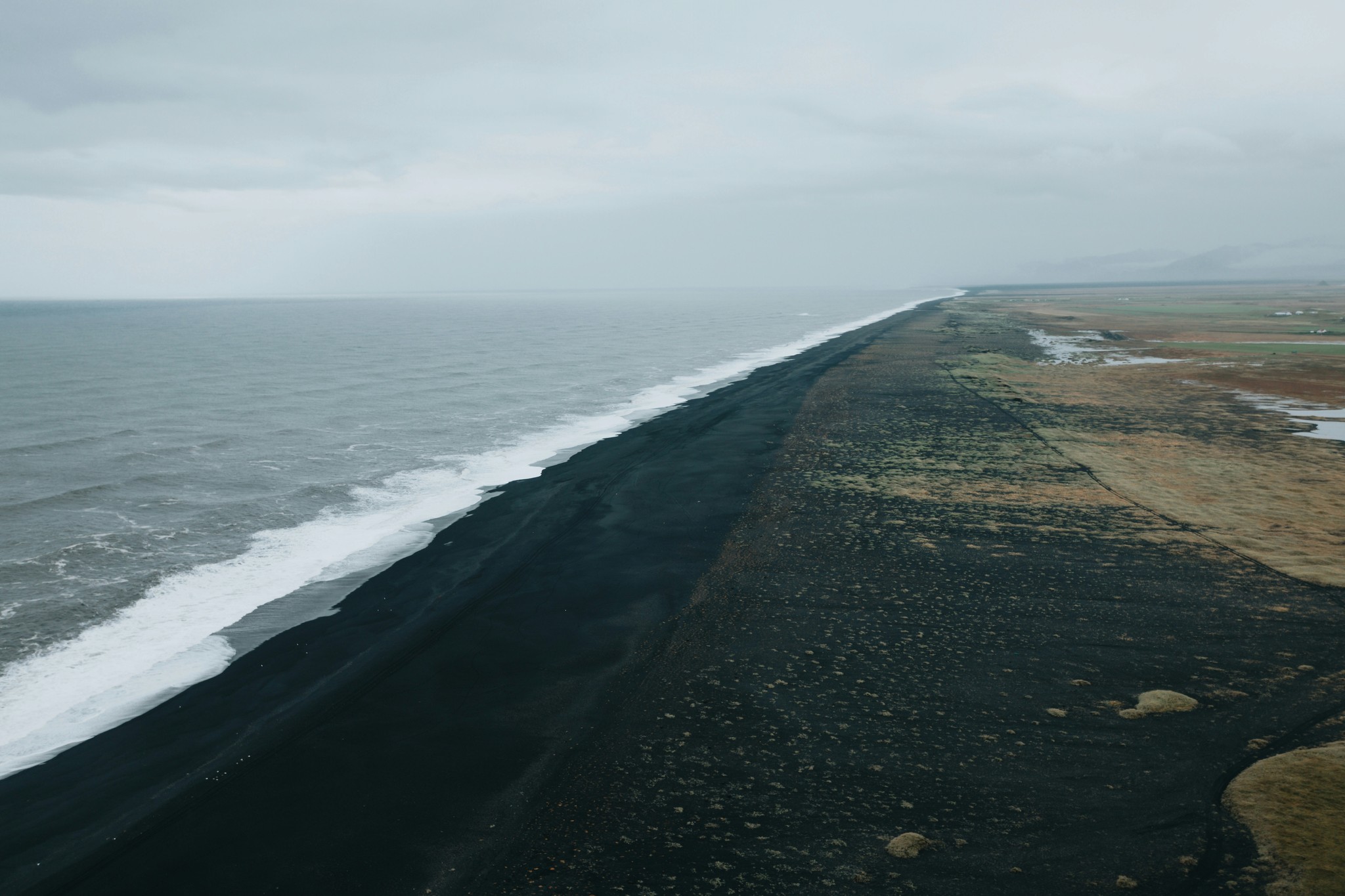 Quiet stretch of black sand beach in Iceland.