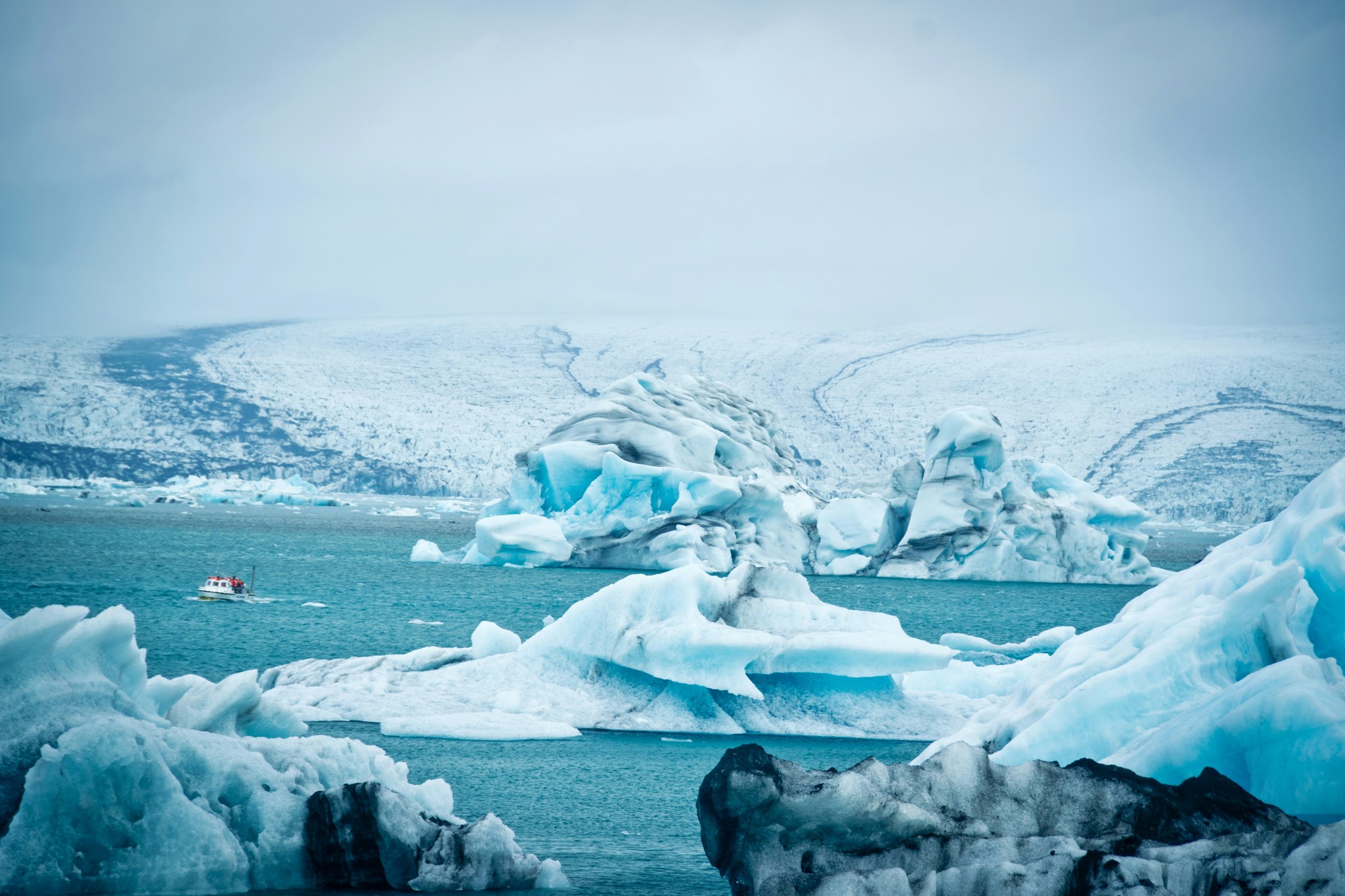 Tourist boat cruising on Jökulsárlón Glacier Lagoon in Iceland.