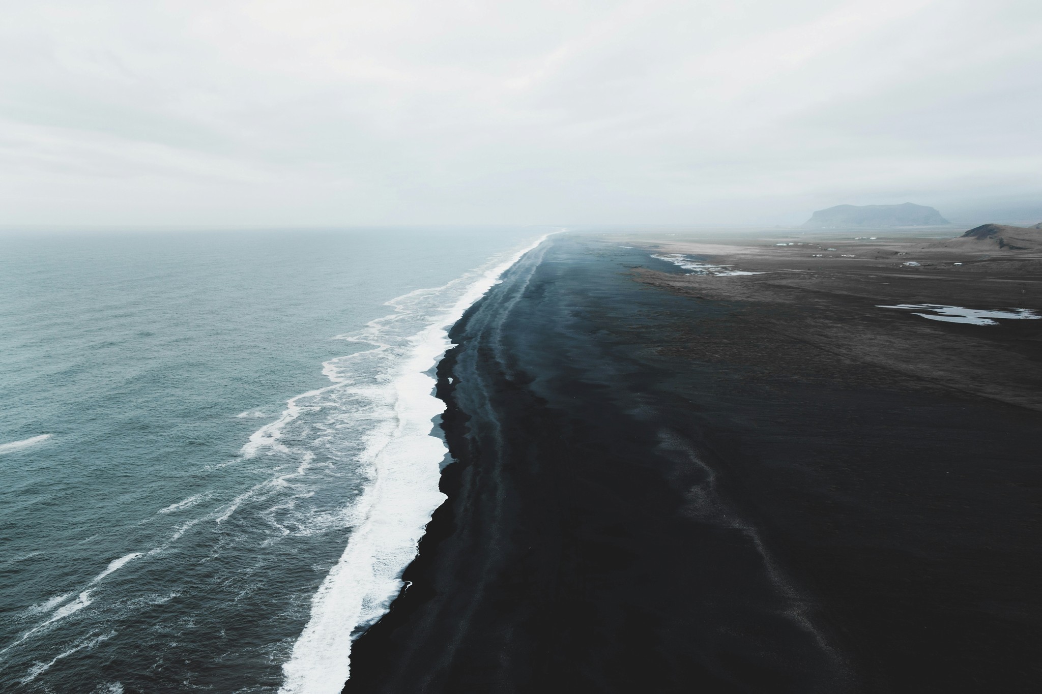 Waves crashing on a black sand beach in Iceland.